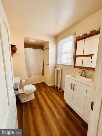a bathroom with a sink toilet and a mirror