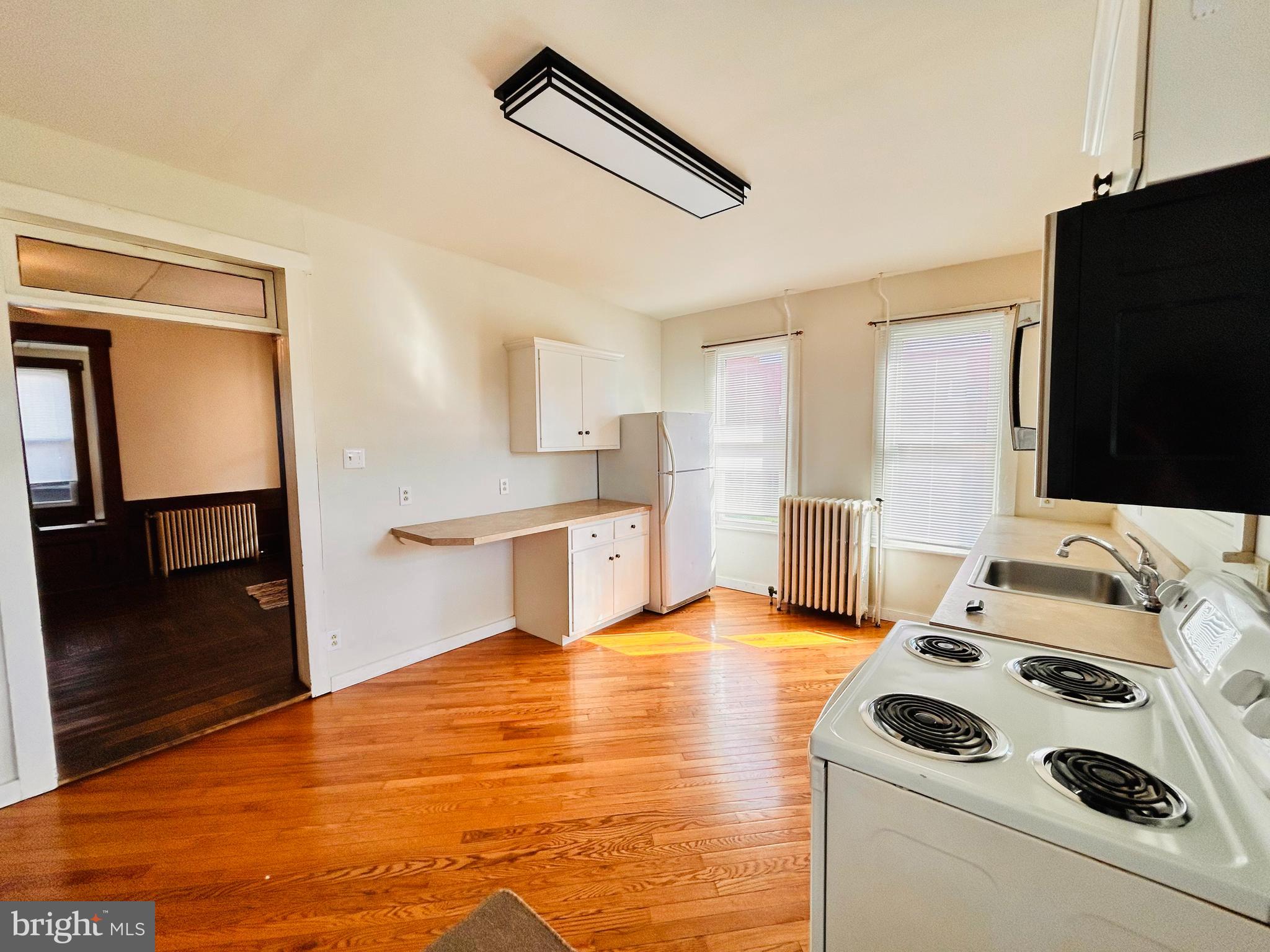 113 West Main Street Millheim, PA 16854 - Photo 22 of 30 a bedroom with a bed and a flat screen tv
