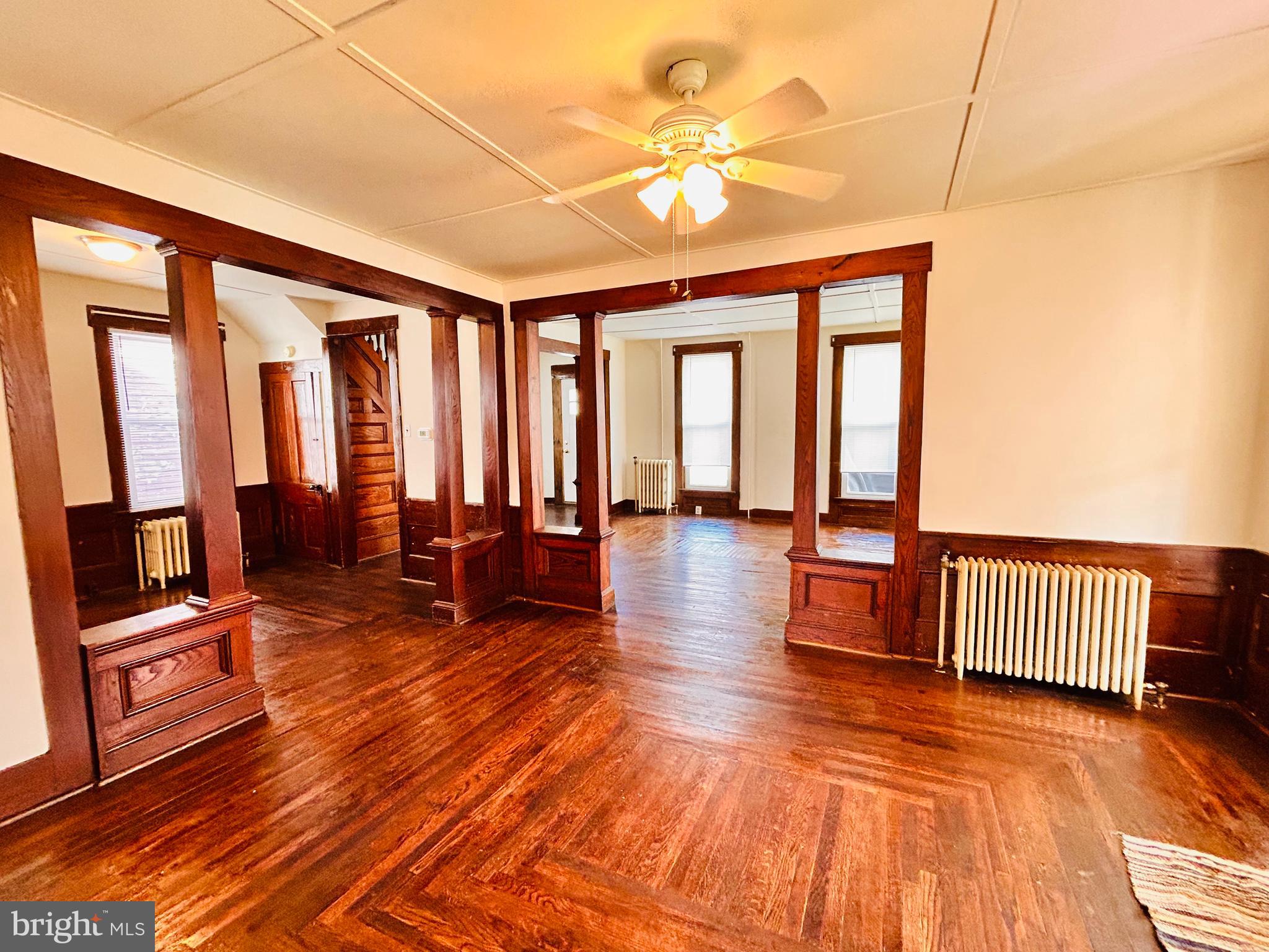 113 West Main Street Millheim, PA 16854 - Photo 28 of 30 a living room with furniture a wooden floor and floor to ceiling windows