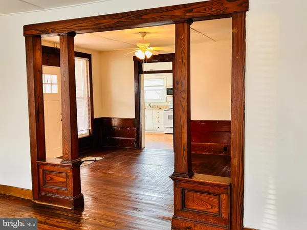a view of front door with wooden floor and chair