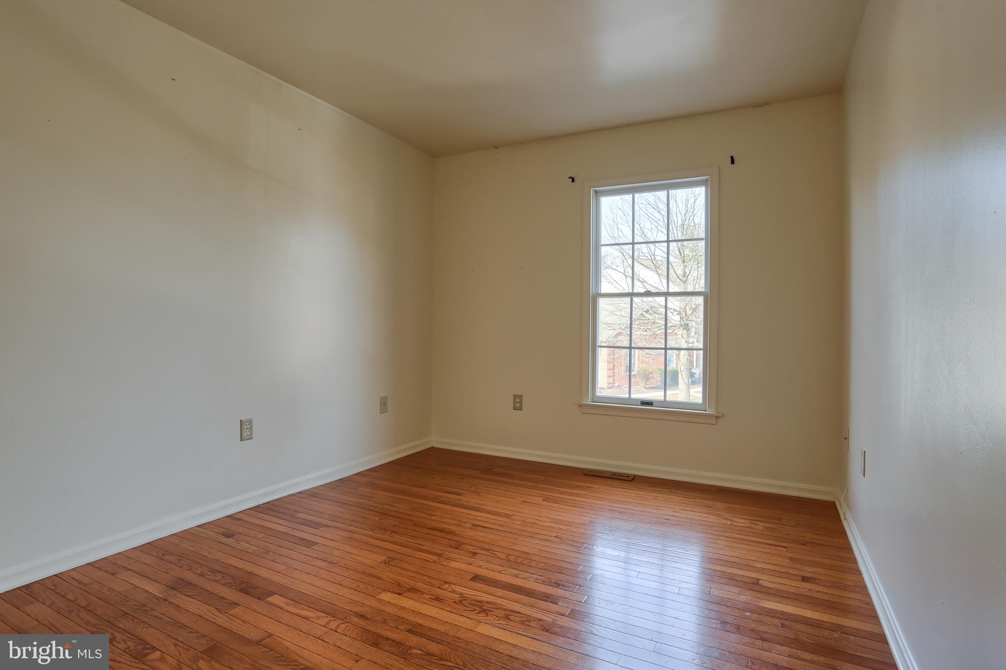 2051 B Raleigh Road, Unit B Hummelstown, PA 17036 - Photo 16 of 27 wooden floor in an empty room with a window