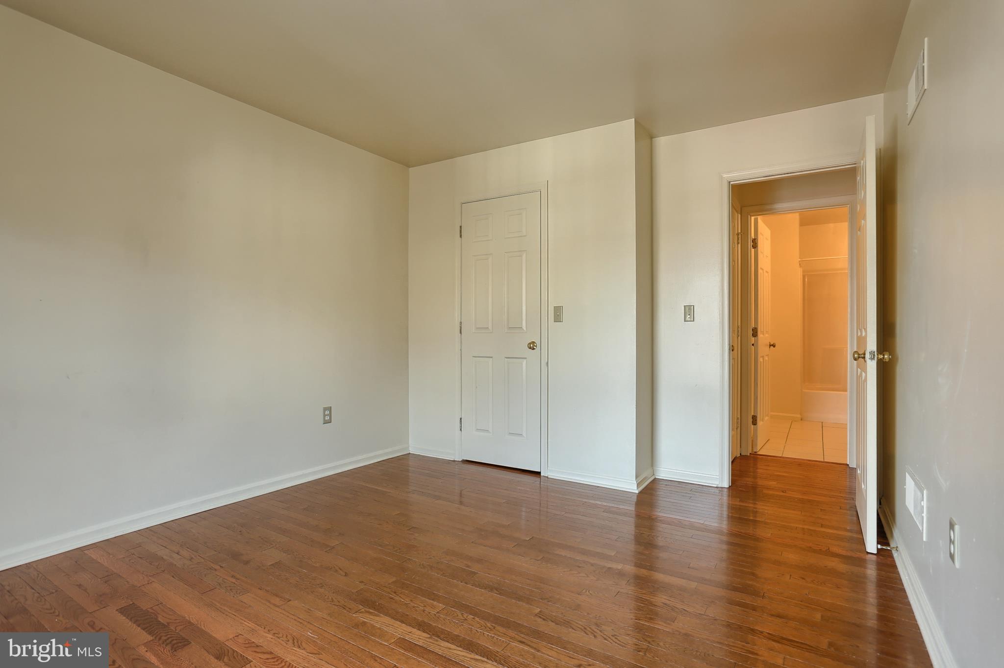 2051 B Raleigh Road, Unit B Hummelstown, PA 17036 - Photo 19 of 27 a view of an empty room with wooden floor