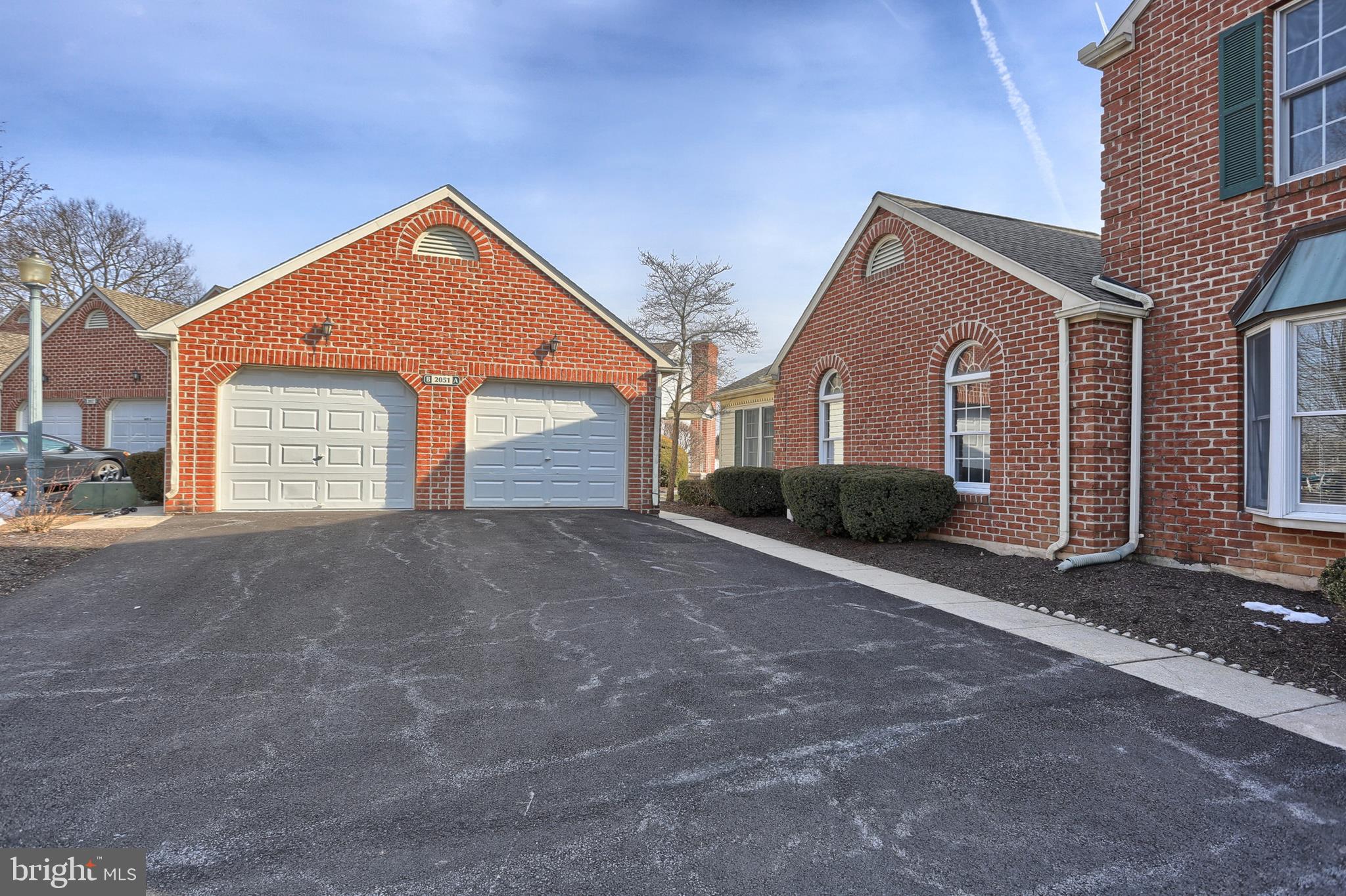 2051 B Raleigh Road, Unit B Hummelstown, PA 17036 - Photo 2 of 27 a front view of a house with a yard and garage