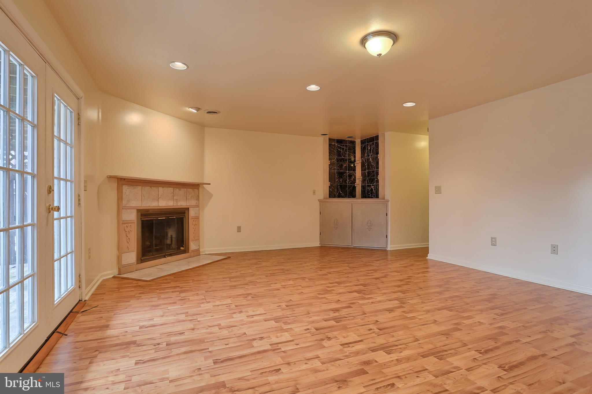 2051 B Raleigh Road, Unit B Hummelstown, PA 17036 - Photo 25 of 27 a view of an empty room with wooden floor and a fireplace