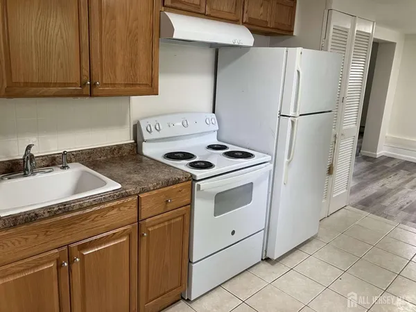 a kitchen with cabinets and a stove top oven