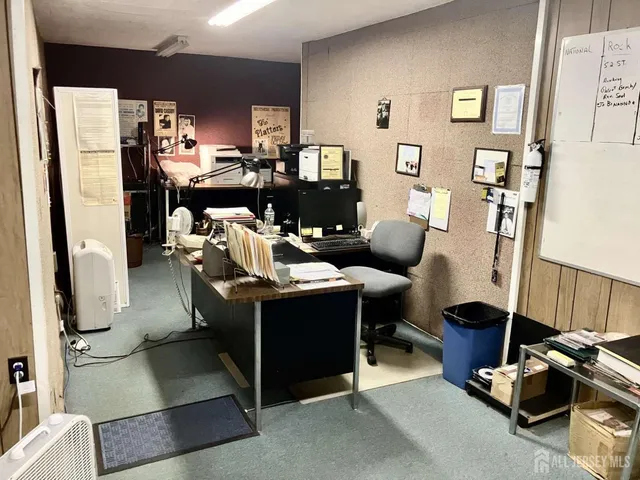 a room with gym equipment and wooden floor