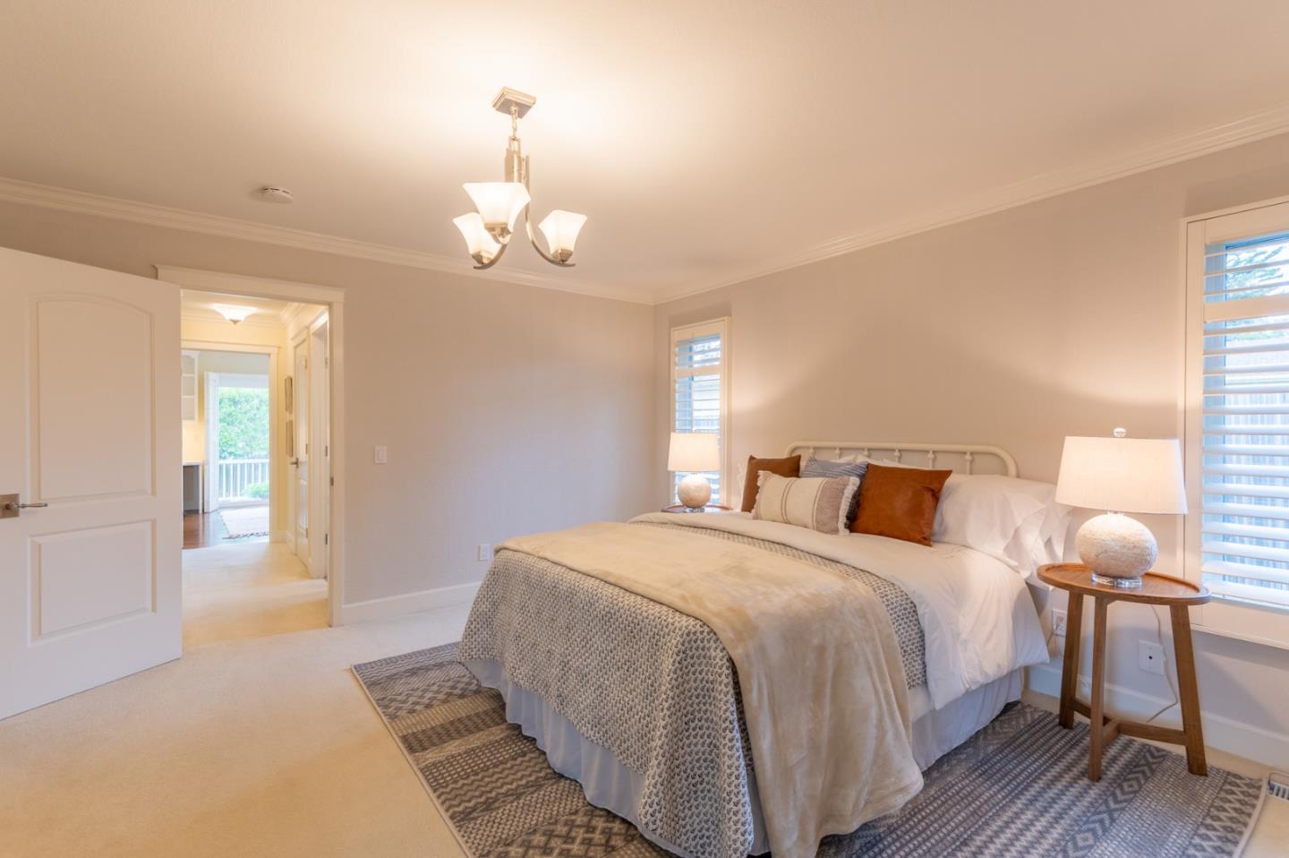 3080 Larkin Road Pebble Beach, CA 93953 - Photo 22 of 34 a bedroom with a bed and wooden floor