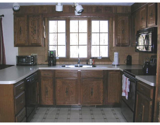 135 Taylor Road Stow, MA 01775 - Photo 4 of 14 a kitchen with a sink a window and cabinets