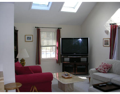 135 Taylor Road Stow, MA 01775 - Photo 8 of 14 a living room with furniture and a flat screen tv