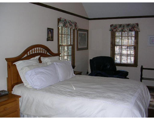135 Taylor Road Stow, MA 01775 - Photo 9 of 14 a bedroom with a bed and window