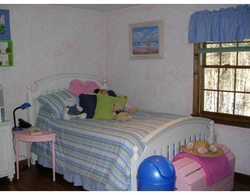 135 Taylor Road Stow, MA 01775 - Photo 10 of 14 a bedroom with a bed and a table in it