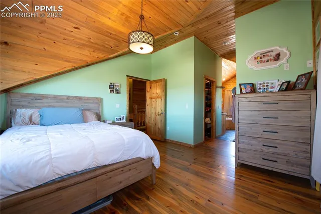 a bedroom with bed and wooden floor