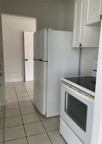 a kitchen with a stove and a refrigerator