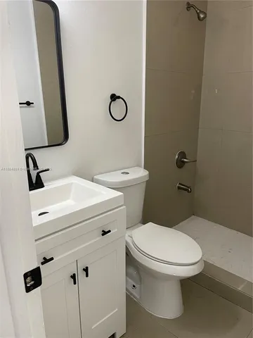 a white toilet sitting next to a bathroom sink