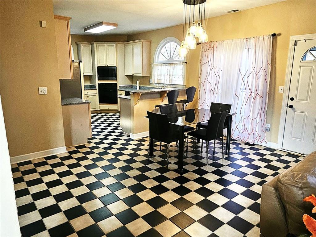 3800 Cherry Ridge Boulevard Decatur, GA 30034 - Photo 7 of 21 a living room with a dining table and a window