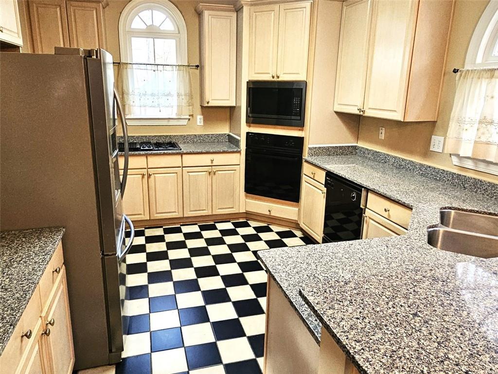 3800 Cherry Ridge Boulevard Decatur, GA 30034 - Photo 8 of 21 a kitchen with a sink a stove a microwave and cabinets
