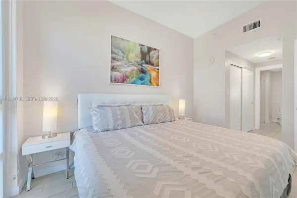 a large white bed in a white room