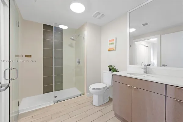 a bathroom with a double vanity sink toilet and shower