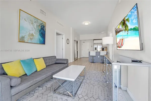 a living room with furniture and a flat screen tv