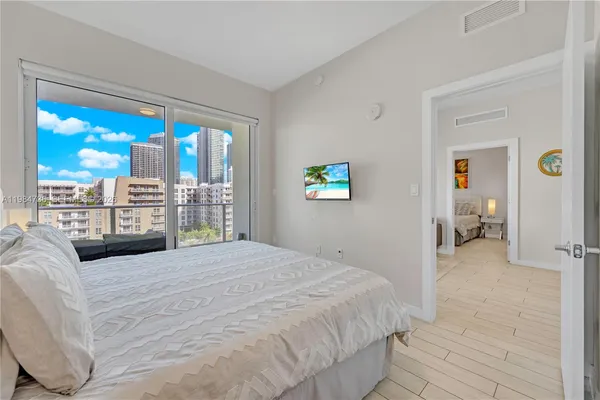 a bedroom with a large bed and a large window