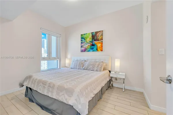 a bedroom with a bed and a window