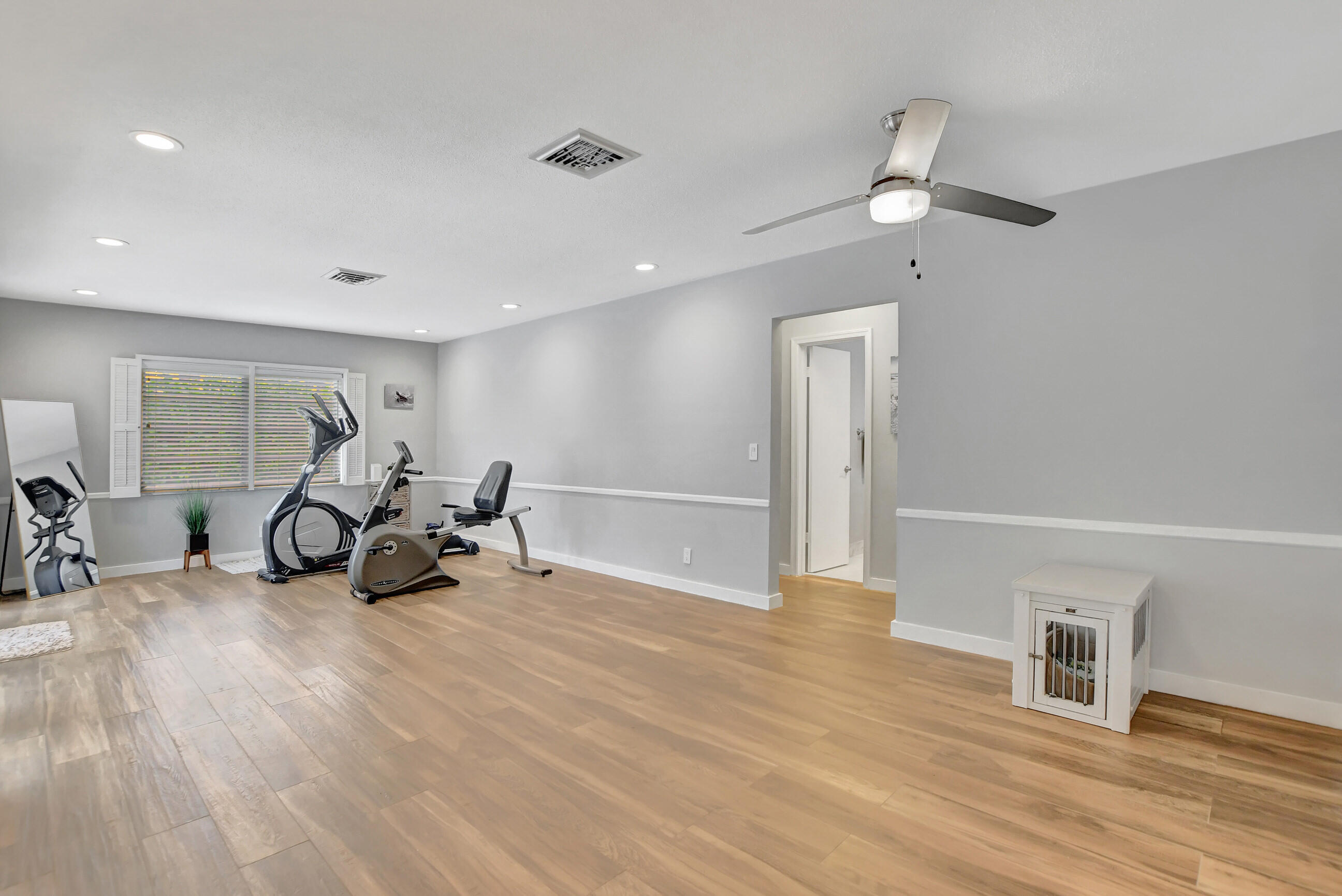 510 Silver Lane Boca Raton, FL 33432 - Photo 7 of 24 a view of a room with gym equipment and wooden floor