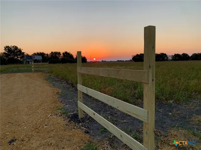 a view of a lake with a yard from a tub