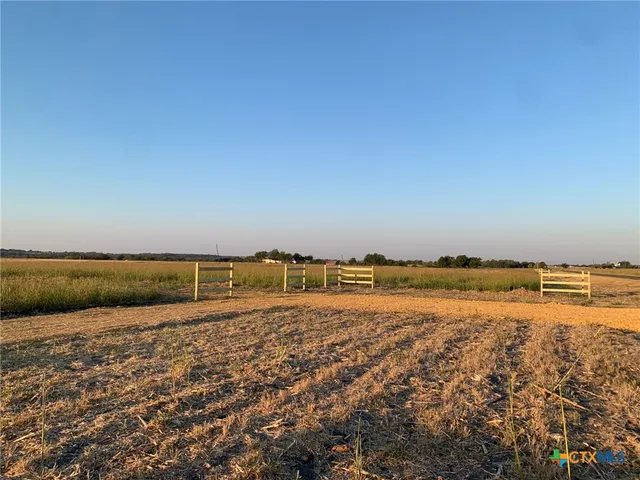 a view of a big yard with lots of green space