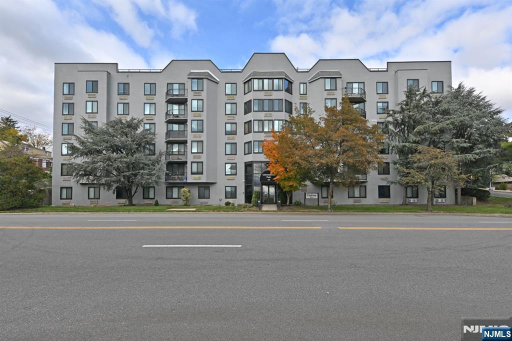 a front view of a residential apartment building with a yard