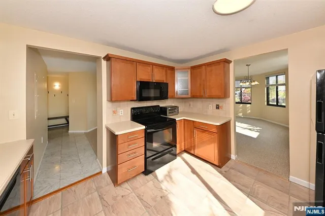 a kitchen with a stove a sink and a microwave