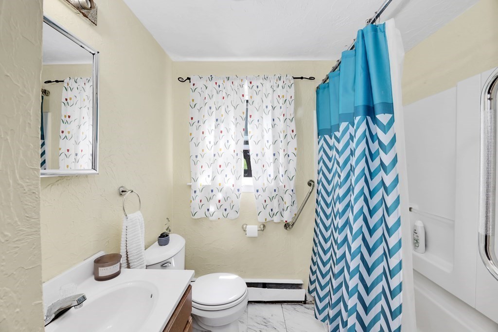 40 Dedham Street Boston, MA 02136 - Photo 13 of 24 a white toilet sitting next to a bathroom sink