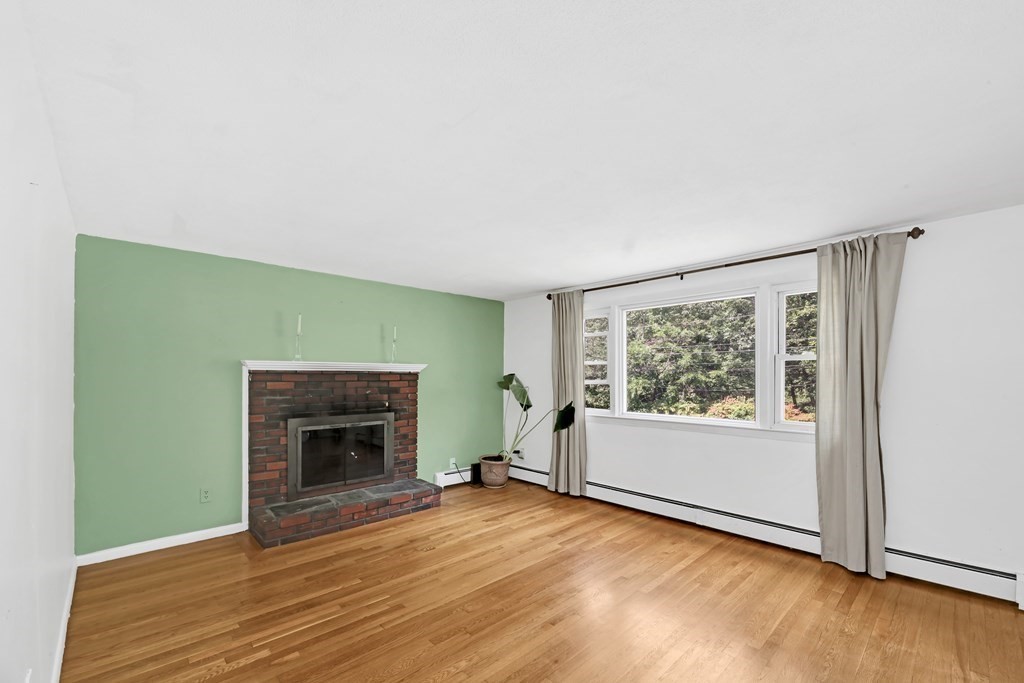 40 Dedham Street Boston, MA 02136 - Photo 2 of 24 a view of empty room with wooden floor and fireplace