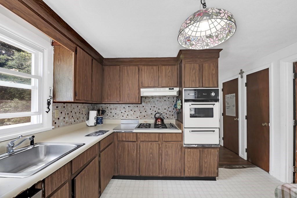 40 Dedham Street Boston, MA 02136 - Photo 3 of 24 a kitchen with a sink a refrigerator and cabinets