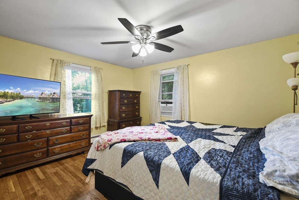 26 Westwood Road Webster, MA 01570 - Photo 14 of 30 a bedroom with a bed and a large window with a flat screen tv