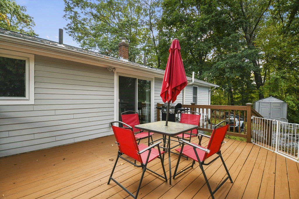 26 Westwood Road Webster, MA 01570 - Photo 29 of 30 a view of a patio with table and chairs with wooden floor and fence