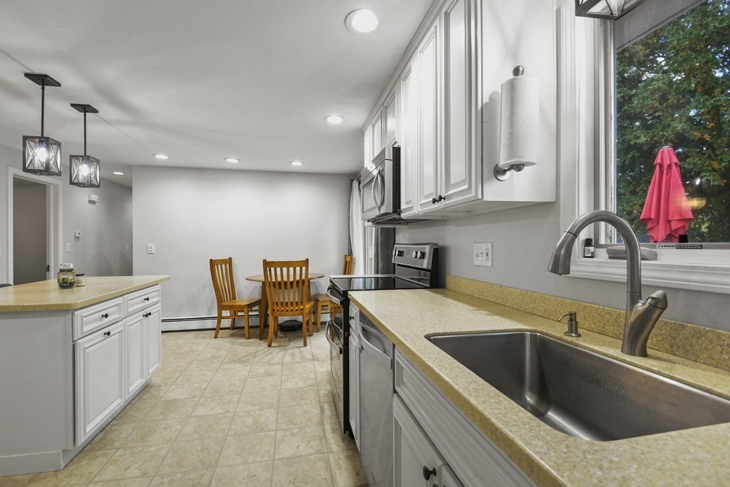 26 Westwood Road Webster, MA 01570 - Photo 7 of 30 a kitchen that has a sink and a stove in it