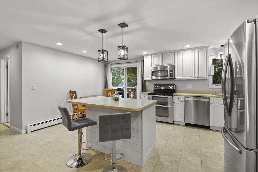 26 Westwood Road Webster, MA 01570 - Photo 8 of 30 a kitchen with stainless steel appliances granite countertop a stove refrigerator and cabinets