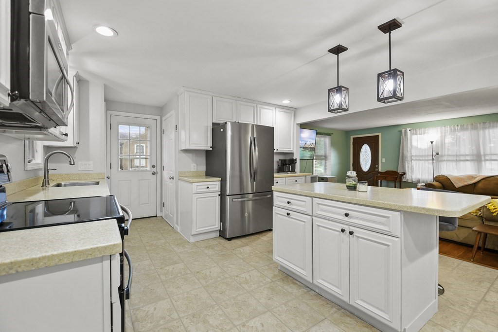 26 Westwood Road Webster, MA 01570 - Photo 10 of 30 a kitchen with refrigerator cabinets and a sink