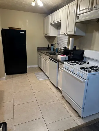 a kitchen with cabinets and appliances