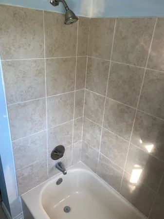 a bathroom with a shower and a bathtub