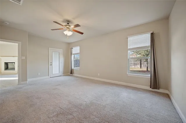 a view of a livingroom with a ceiling fan and window