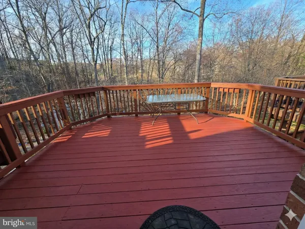 a view of deck with trees and wooden floor