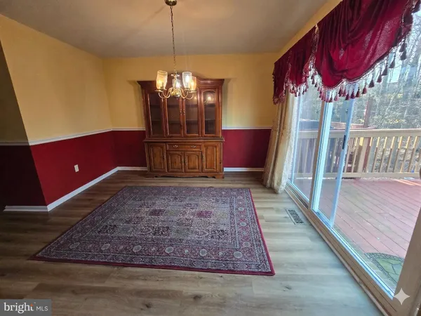 a view of a livingroom with furniture window and wooden floor