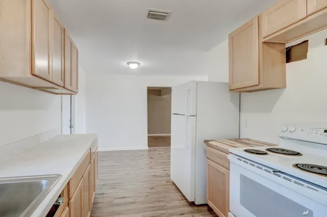 a kitchen with a stove and a refrigerator