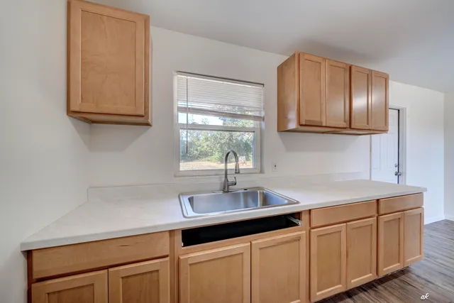 a kitchen with white cabinets and a sink