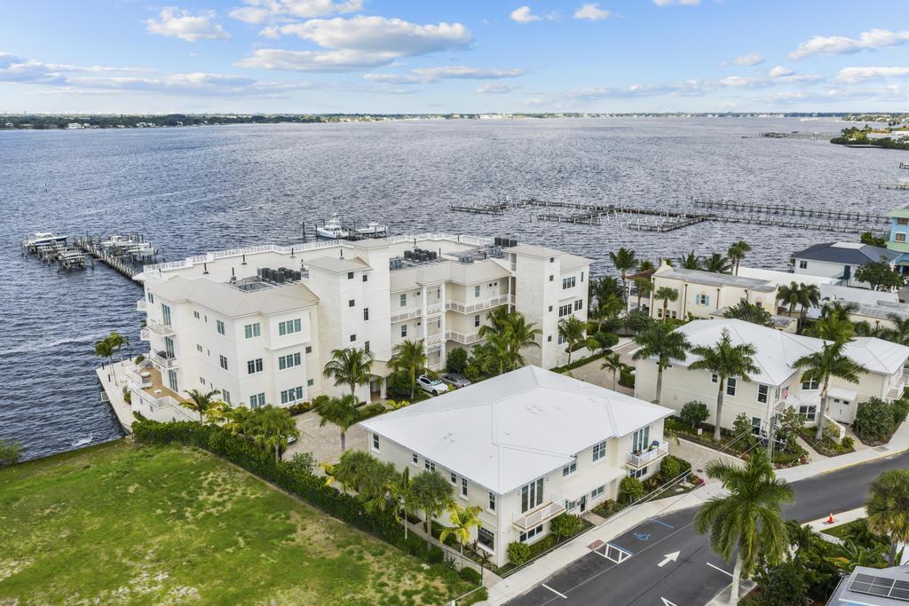 53 Southeast Seminole Street, Unit A Stuart, FL 34994 - Photo 2 of 75 a aerial view of a house with a garden and lake view