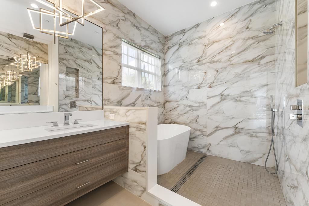 53 Southeast Seminole Street, Unit A Stuart, FL 34994 - Photo 36 of 75 a bathroom with a sink and a bathtub