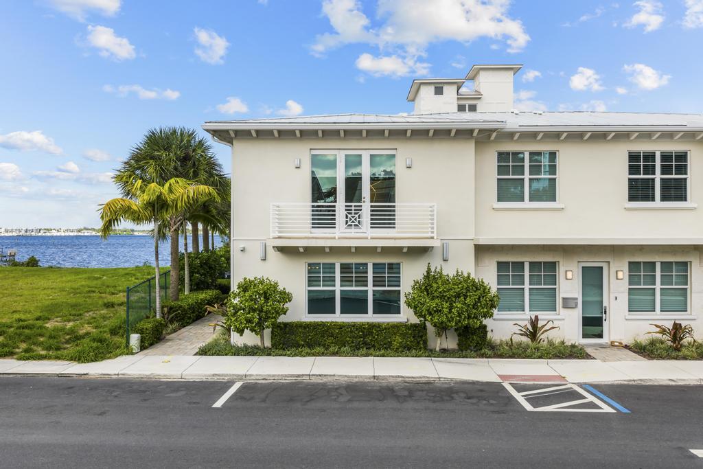 53 Southeast Seminole Street, Unit A Stuart, FL 34994 - Photo 4 of 75 a front view of a house with a garden and plants