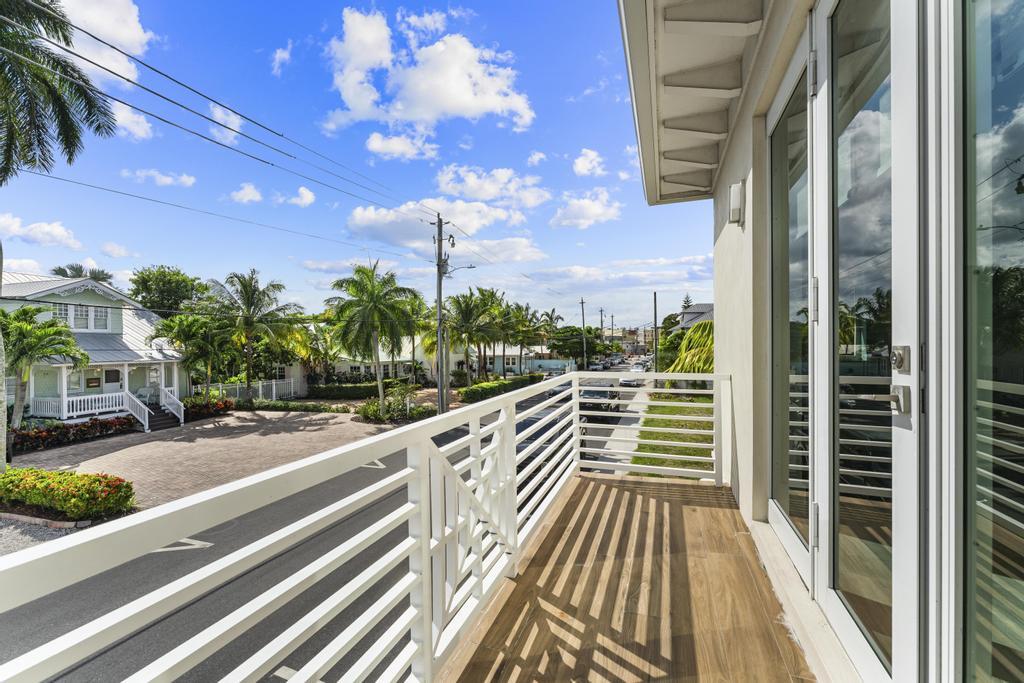 53 Southeast Seminole Street, Unit A Stuart, FL 34994 - Photo 43 of 75 a view of a balcony with wooden floor and potted plants