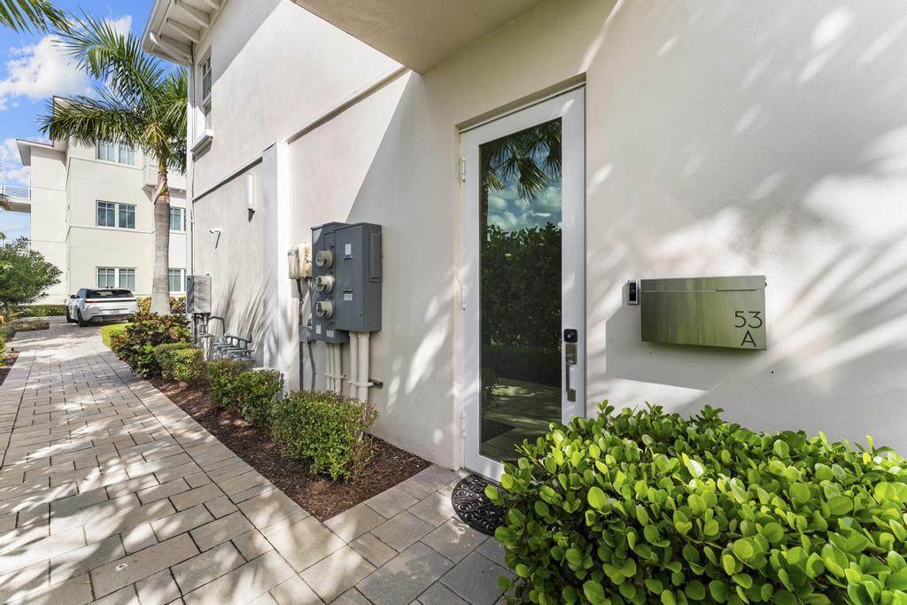 53 Southeast Seminole Street, Unit A Stuart, FL 34994 - Photo 60 of 75 a front view of a house with garden